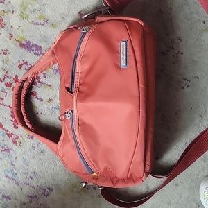 La Packmore burnt orange nylon crossbody bag.  Water repellent and washable.